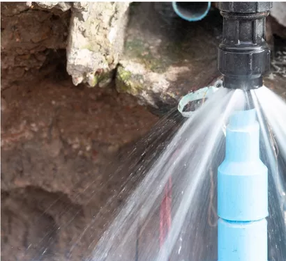Technician replacing a burst pipe section in Tempe
