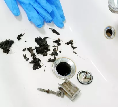 Technician using a drain snake in Tempe