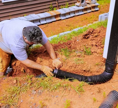 Plumber fixing a drainage issue in a Tempe property