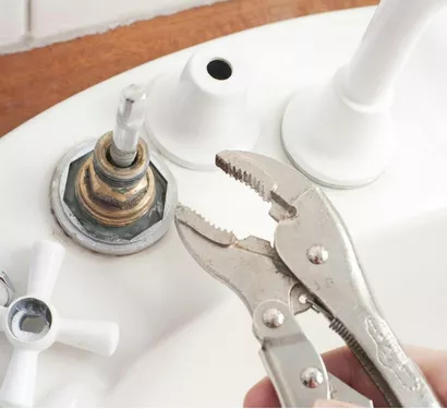 Plumber installing a new faucet in a Tempe home