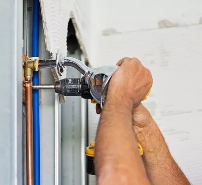 Plumber installing a new plumbing fixture in Tempe