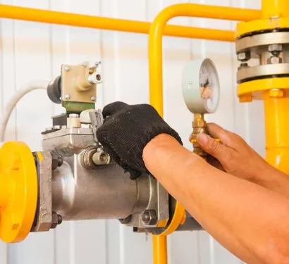 Plumber repairing a gas line in a Tempe home