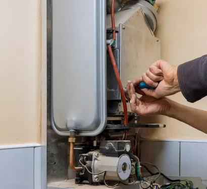 Technician connecting a gas line in a Tempe kitchen