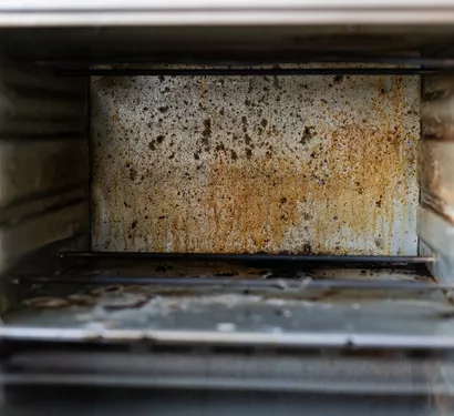 Technician cleaning a grease trap in a Tempe restaurant