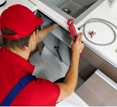 Technician installing a kitchen faucet in Tempe