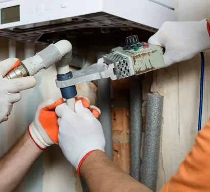 Technician insulating pipes in a Tempe home