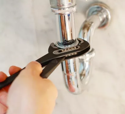 Plumber fixing a leak in a Chandler home