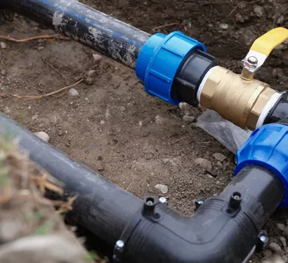 Technician inspecting home plumbing in Tempe