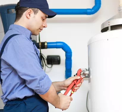 Technician installing a water softener in a Tempe home